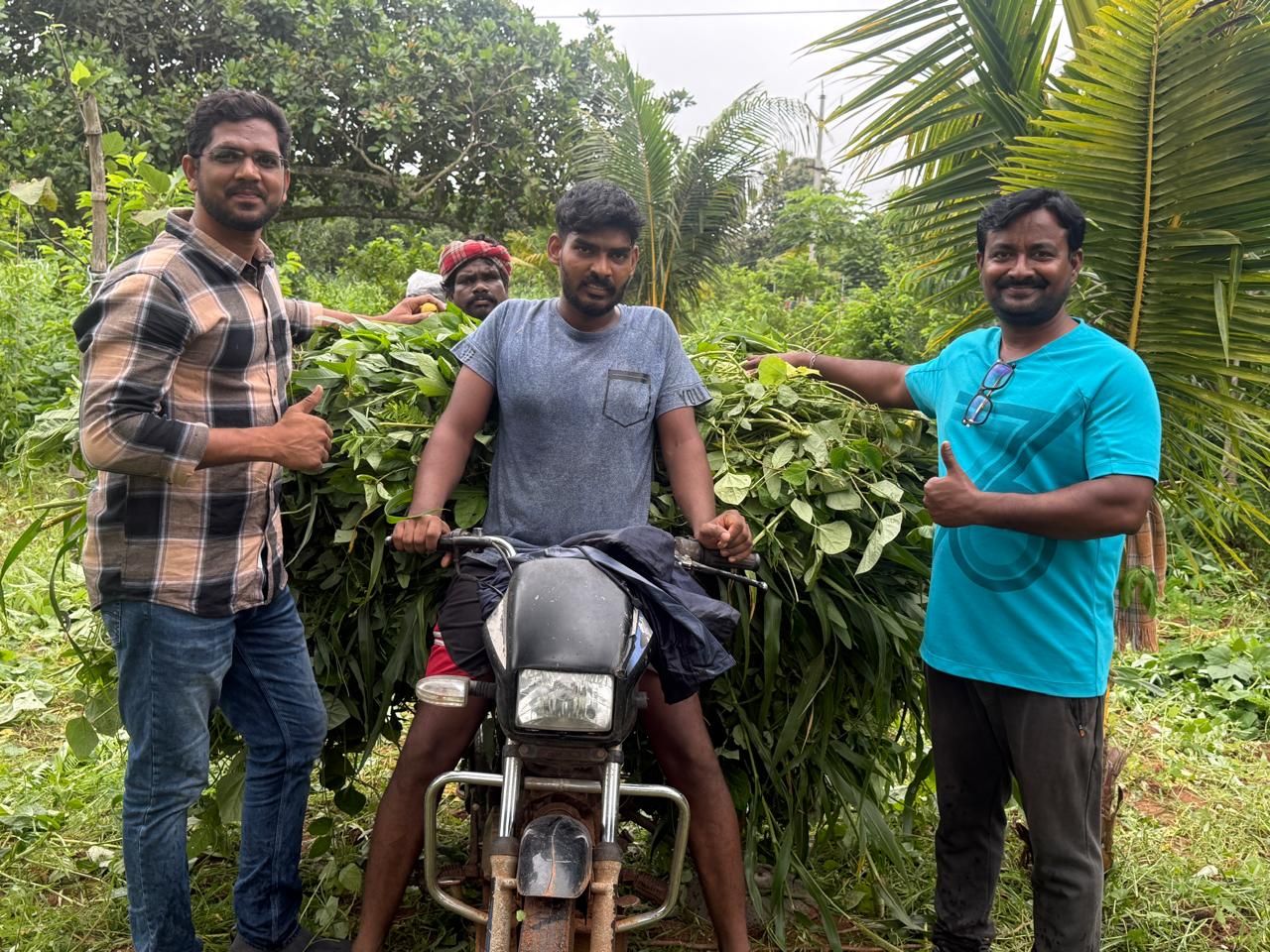 Foundation members with a motorbike loaded with freshly cut green fodder