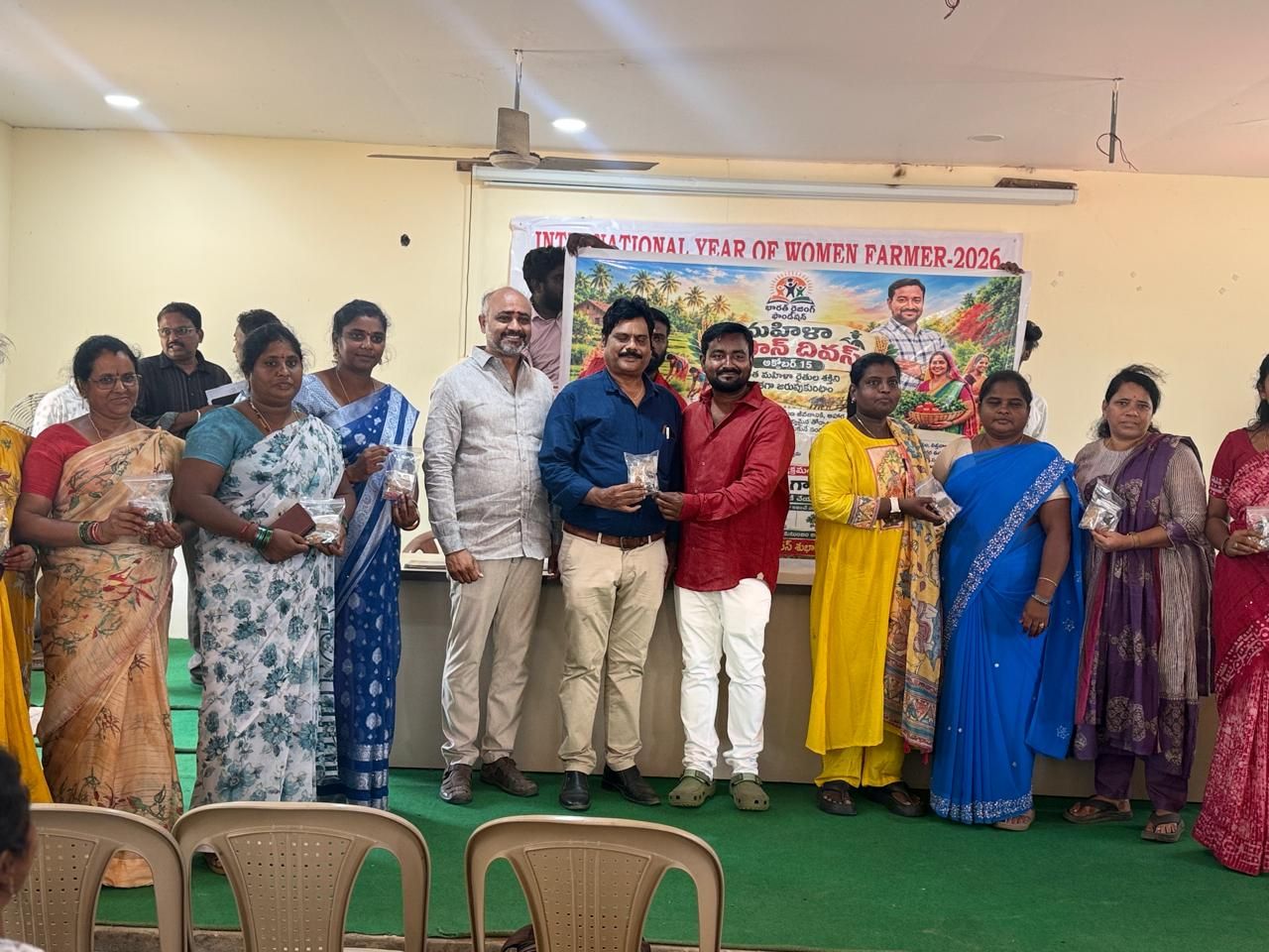 Women farmers holding seed packets at the International Year of Women Farmer 2026 event